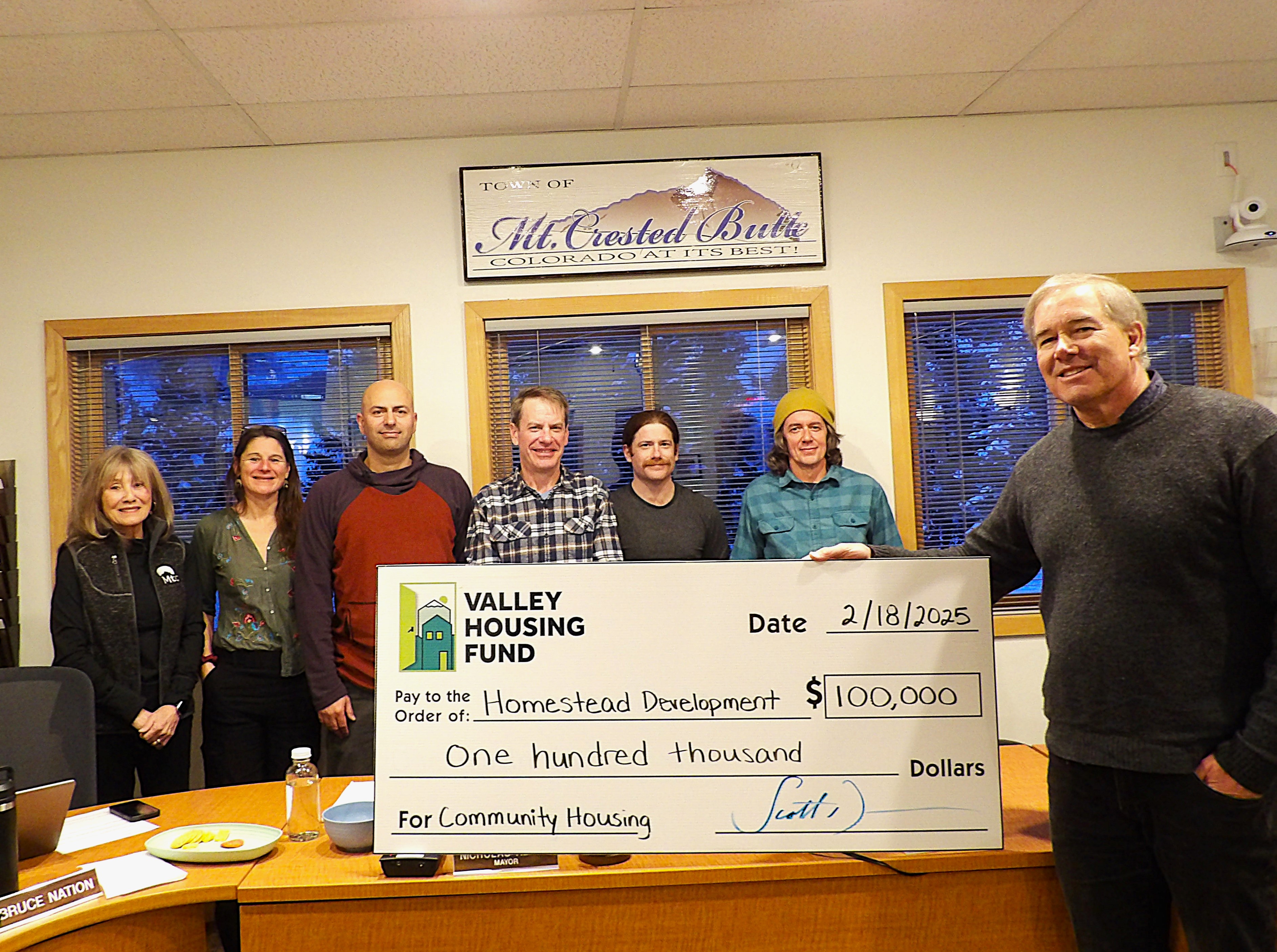 A picture of the Valley Housing fund issuing a large award check for $100,000 to the Mt. Crested Butte Town Council at the Tuesday, Feb. 18, 2025 meeting.